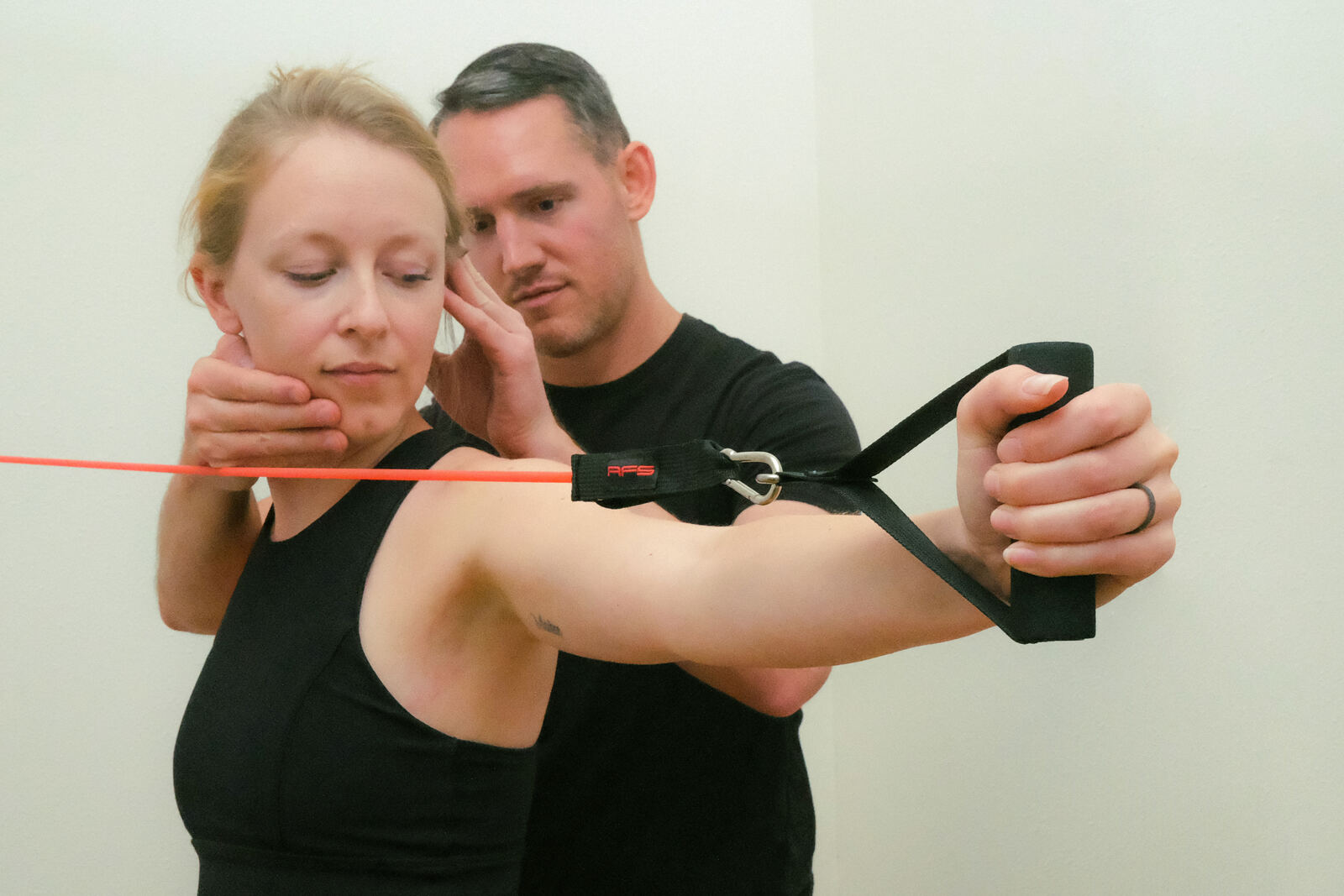 Dr. Pratt coaching a patient through a banded shoulder exercise